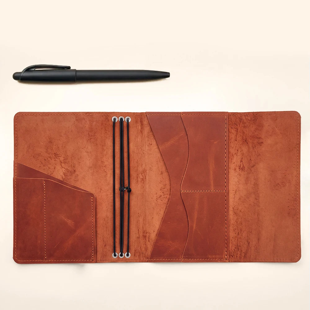 Genuine leather notebook cover with three elastic bands, interior pockets, and pen holder.