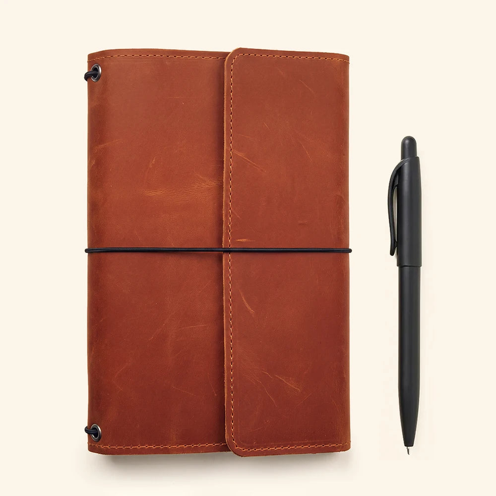 Leather writing cover featuring secure elastic notebook holders and premium handcrafted leather finish.