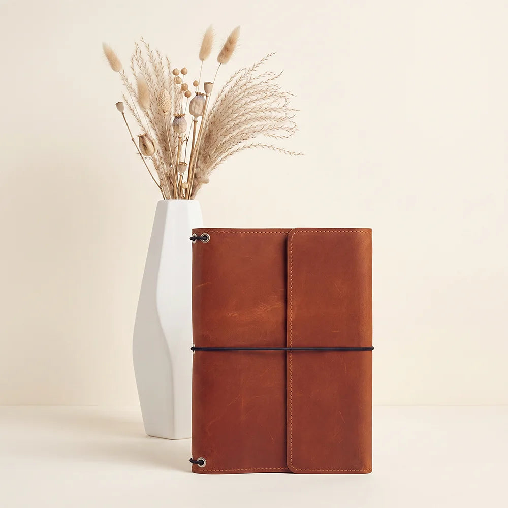 Genuine leather journal cover featuring three elastic bands and spacious interior storage pockets.