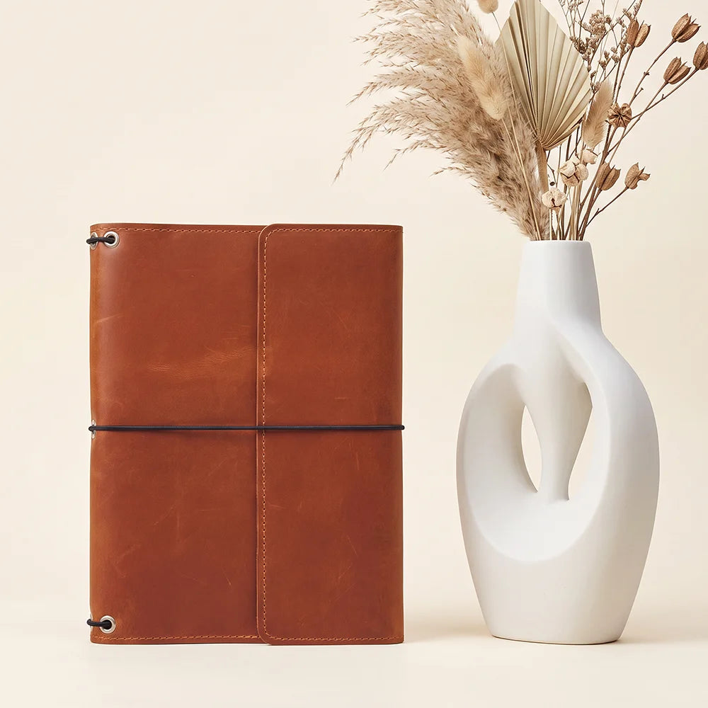 Genuine leather journal cover featuring three elastic bands, inner pockets, and refillable design.