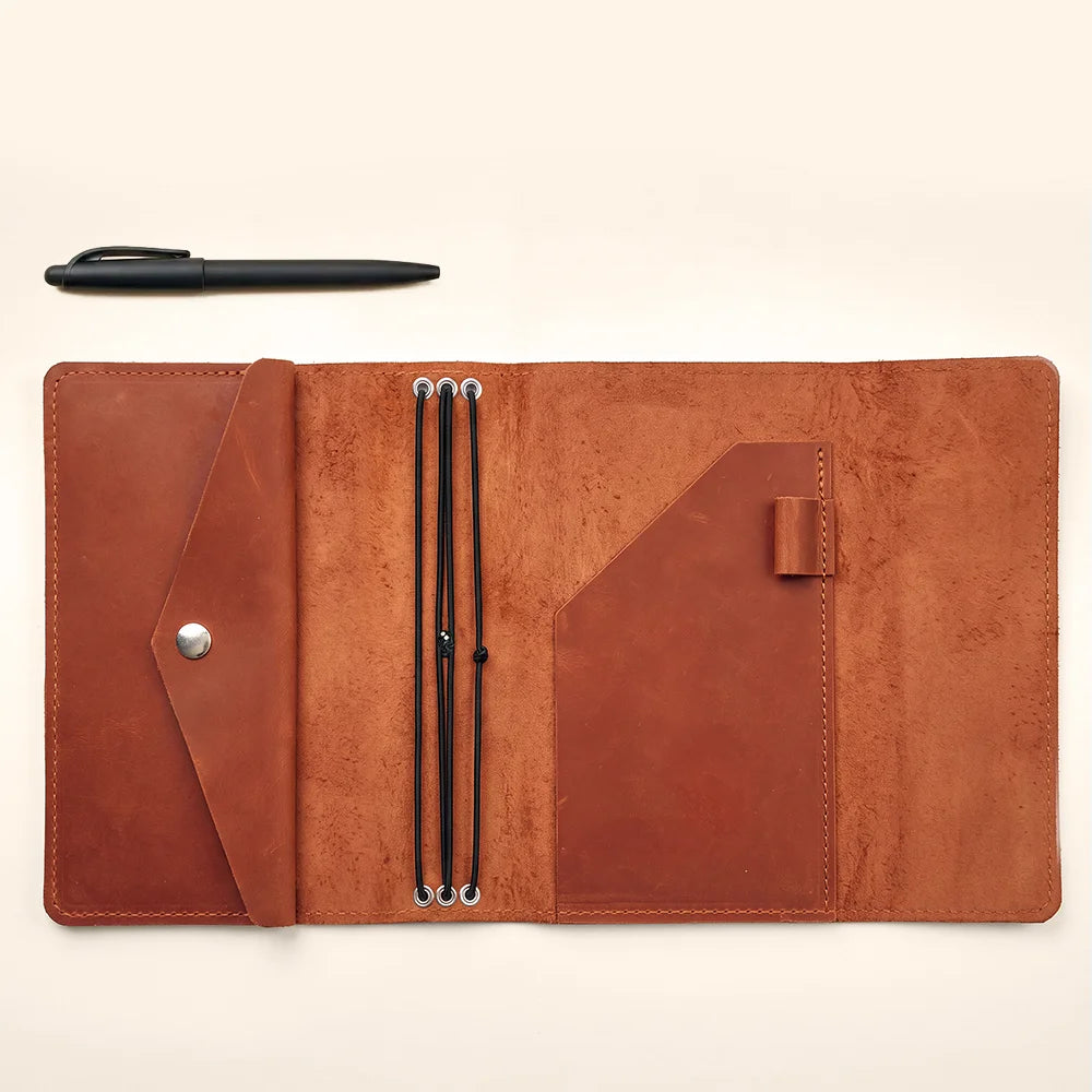 Handmade leather notebook cover with refillable inserts for everyday journaling and organized planning.