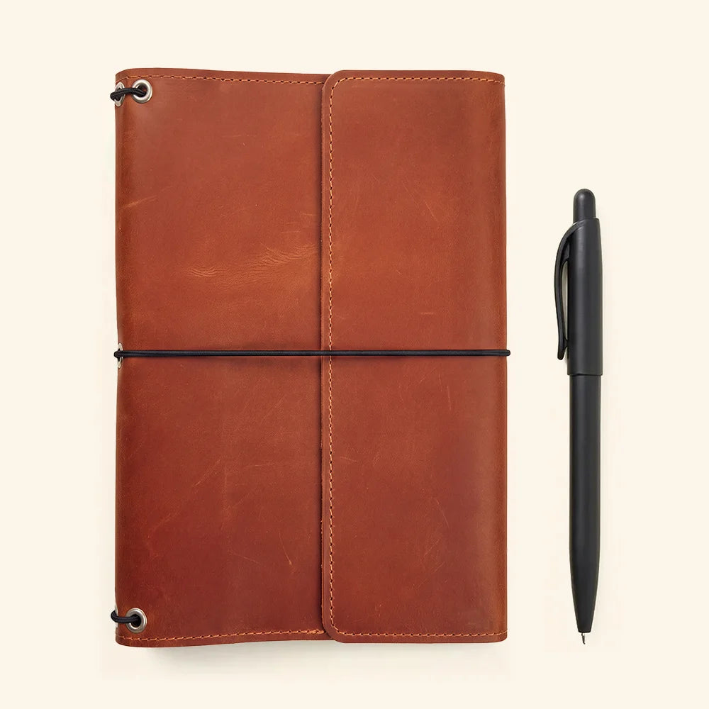 Premium leather notebook case with flexible elastic bands and practical storage compartments inside.