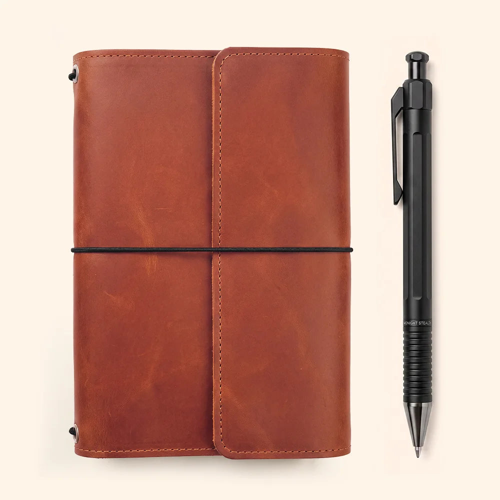 Genuine leather cover for notebooks featuring interior pockets and a convenient pen holder