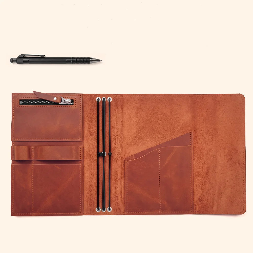 Handmade leather notebook cover with neatly stitched pockets and a convenient pen loop inside.
