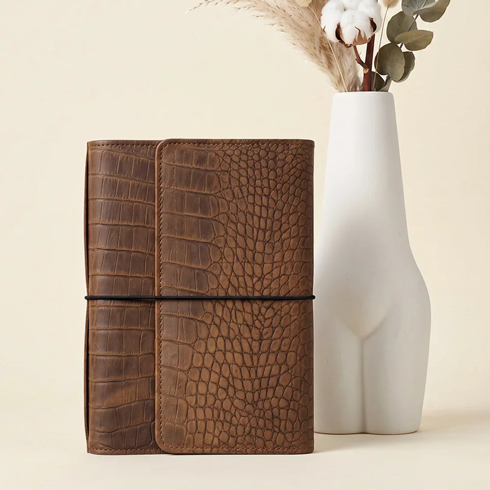 Premium leather organizer with elastic notebook holders and spacious zippered interior pocket.