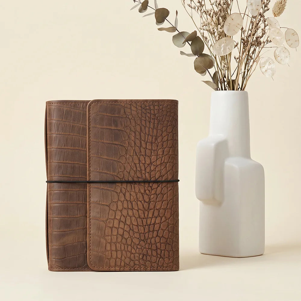 Genuine leather journal cover with functional interior pockets and six elastic notebook bands.