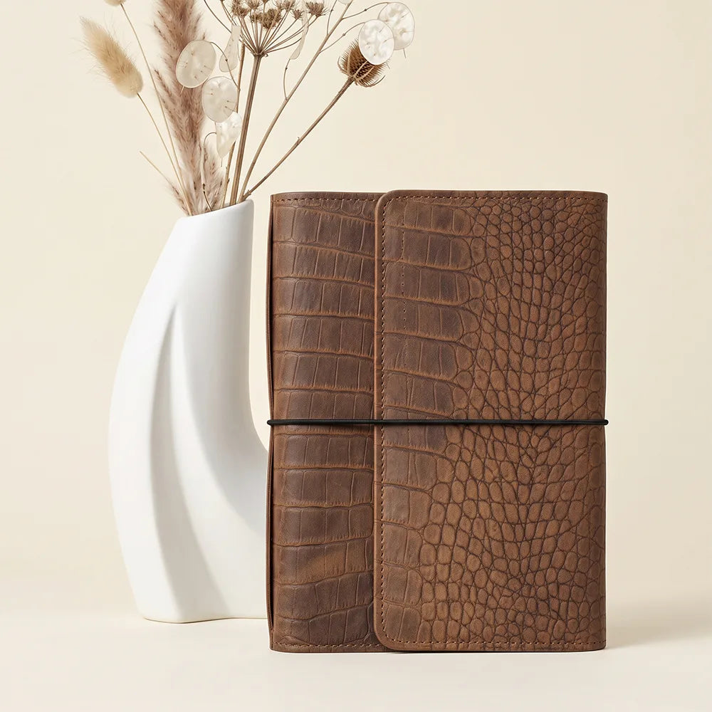 Genuine leather journal cover with small interior pockets and large zippered storage compartment.