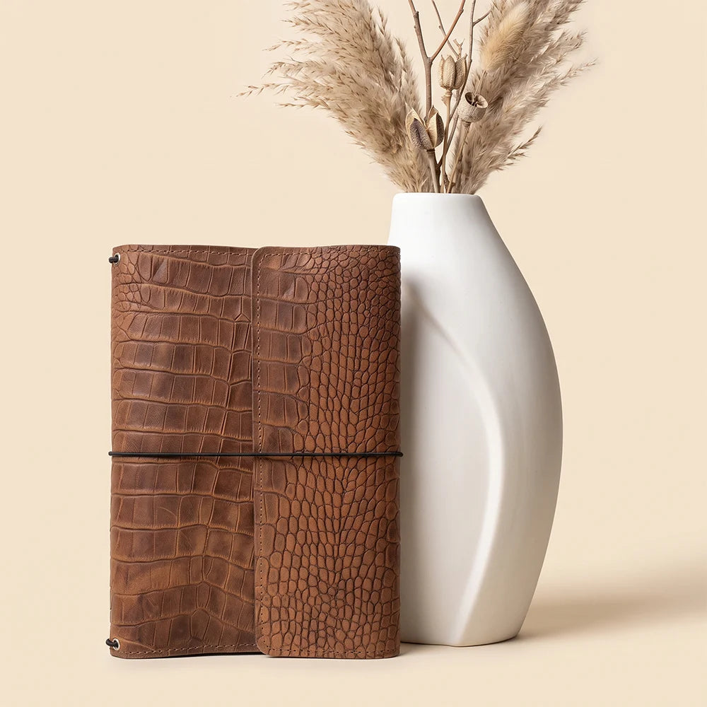 Full grain leather journal cover with refillable design and practical inside pockets.