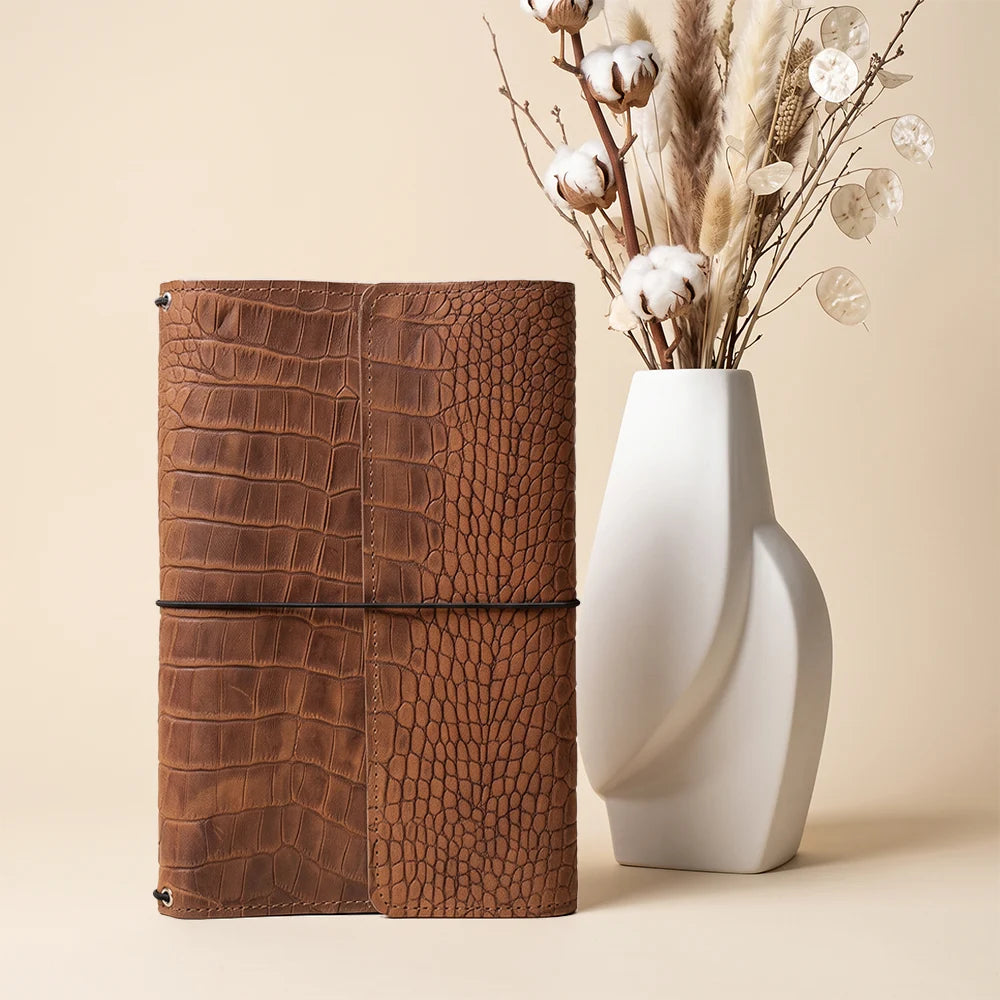 Durable leather journal cover with refillable elastic system and convenient inside organization.