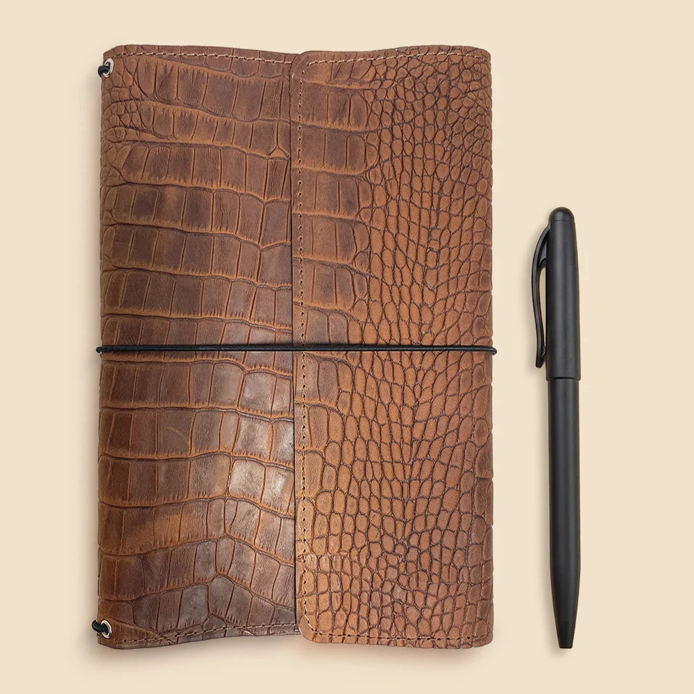 Refillable genuine leather cover with three elastic notebook holders and functional compartments.