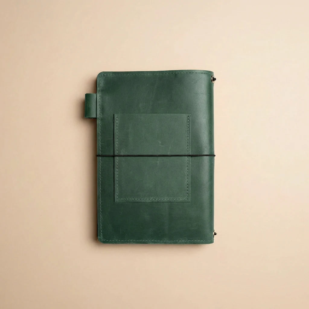 Green leather notebook on a beige background