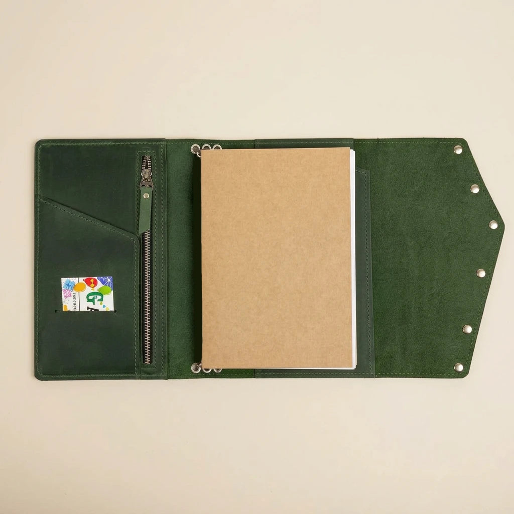 Green leather journal with a card holder and open space for a notebook on a beige background
