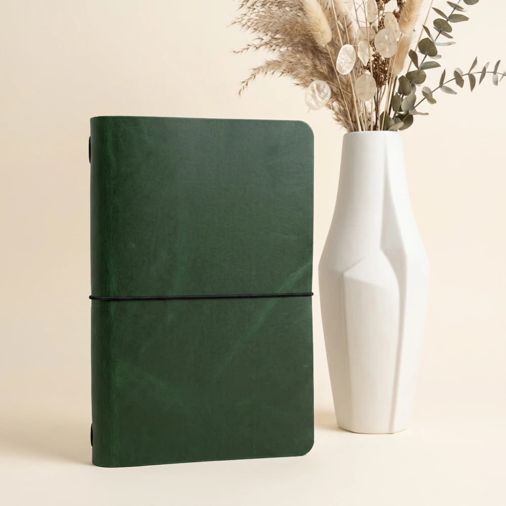 Soft genuine leather cover surrounding a plain journal with flexible elastic retention.