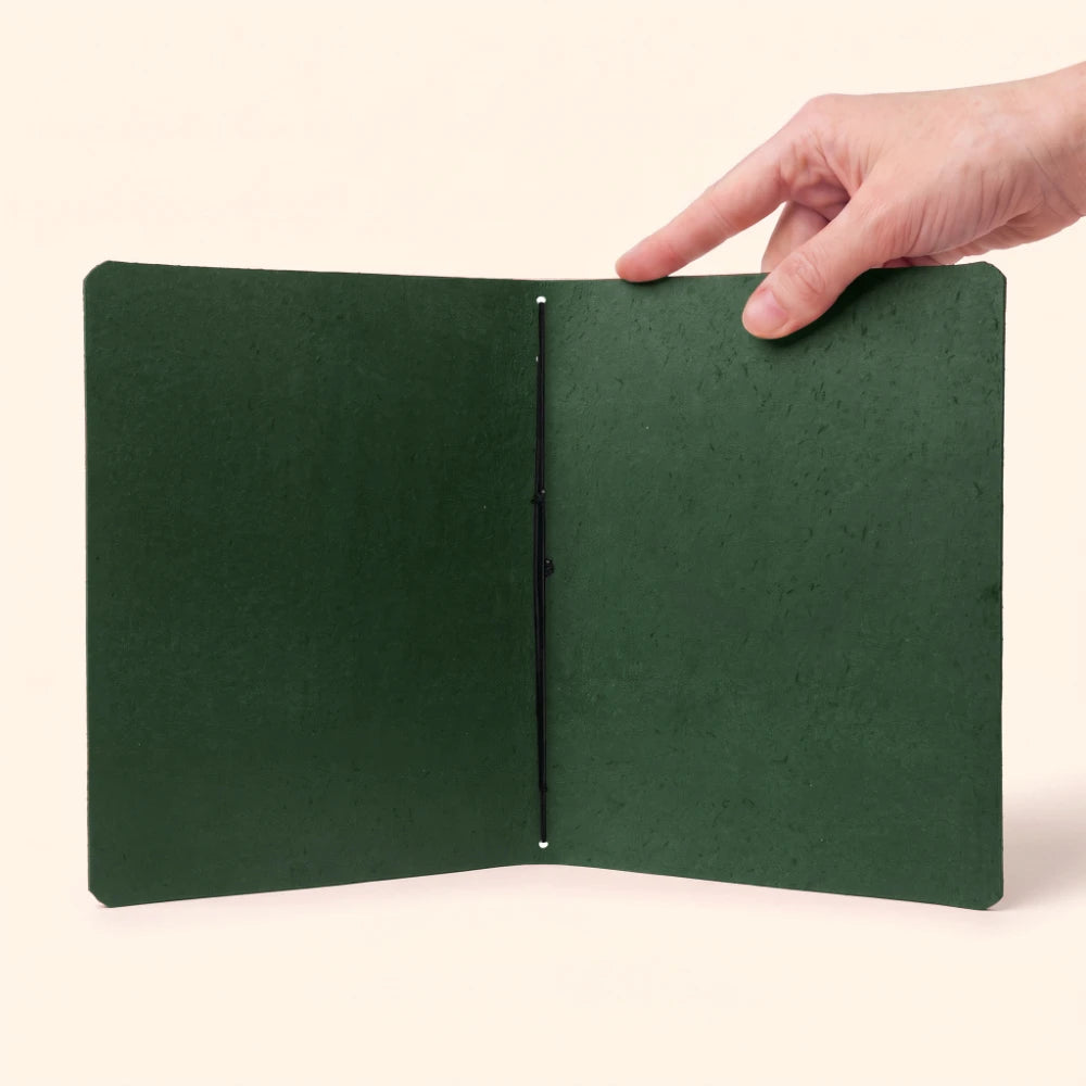 Leather notebook cover shown with plain journal pages and one flexible elastic holder.