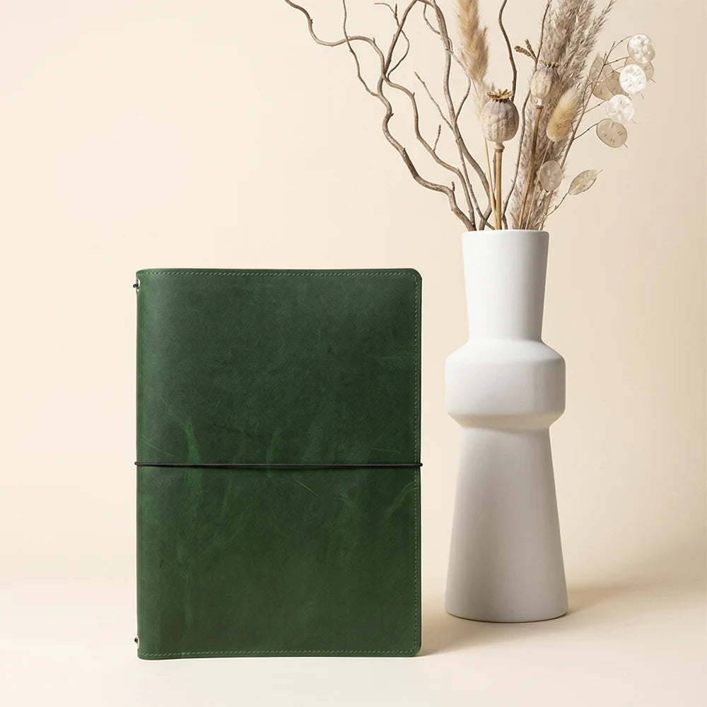 Natural leather notebook cover with a practical insert system and organized pocket layout.