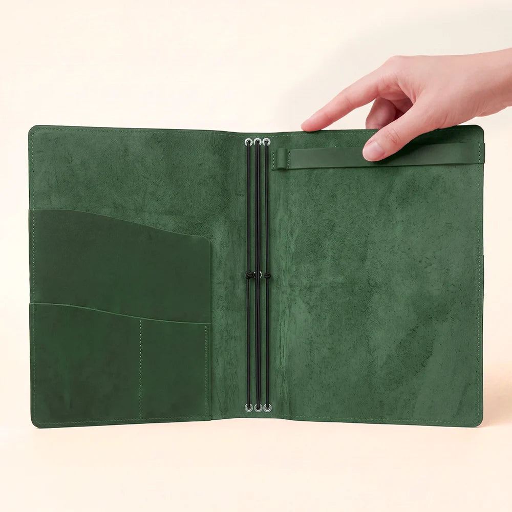 Interior detail of a leather organizer with elastic insert holders and storage sections.