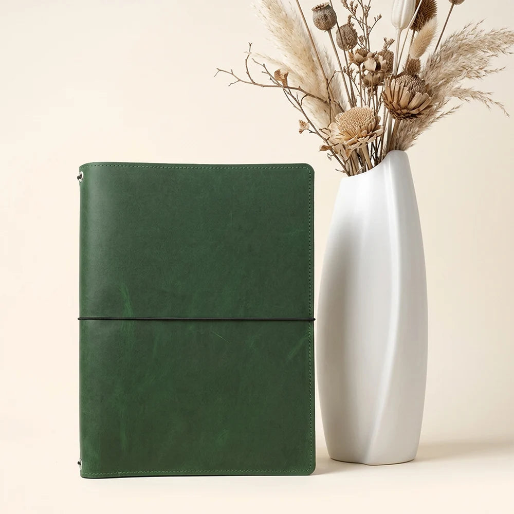 Classic leather notebook cover with three elastic bands and organized interior storage.