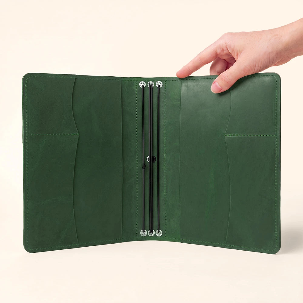 Leather notebook folio with handcrafted interior organizers and secure stitched pen loop.