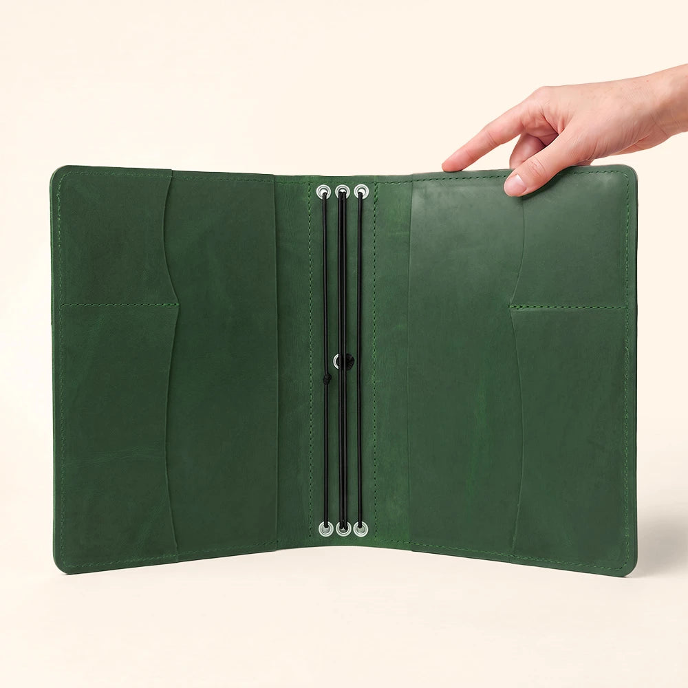 Genuine leather notebook folder with secure interior storage and integrated pen carrying loop.