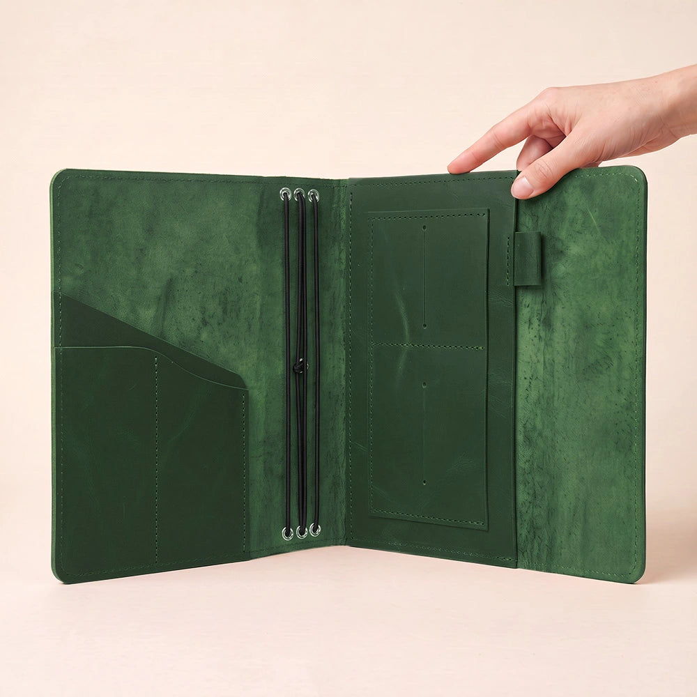 Handmade notebook organizer made from natural leather with interior storage and pen keeper.