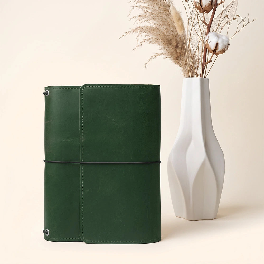 Leather writing folio with organized compartments and practical stitched leather pen keeper.