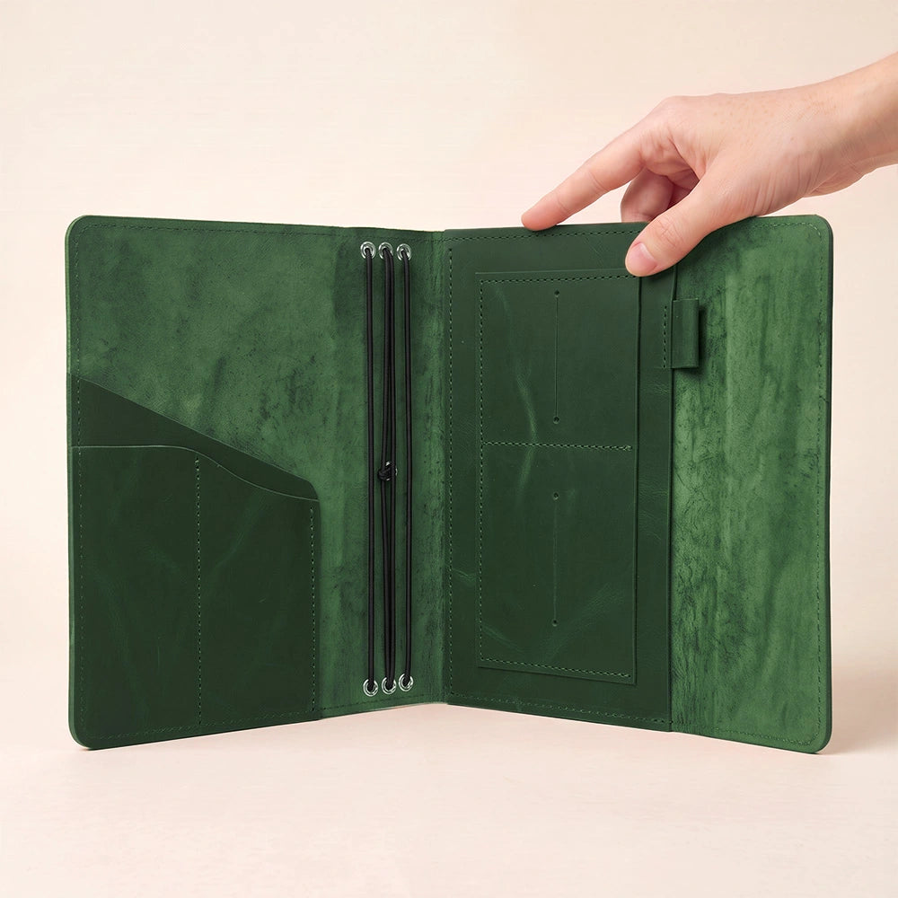 Elegant leather notebook organizer with dedicated storage pockets and convenient pen loop inside.
