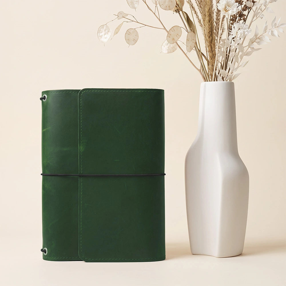 Premium notebook cover crafted from genuine leather with interior organizer and pen loop.