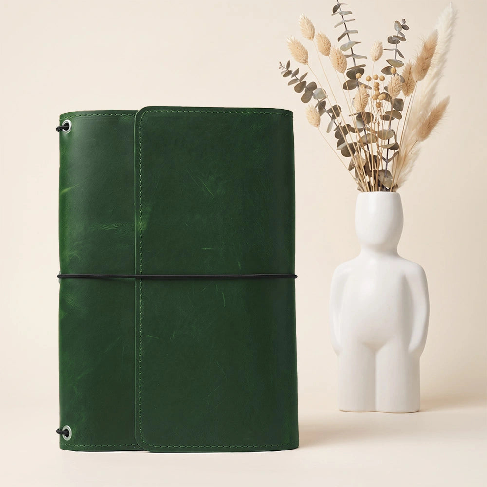 Leather notebook cover designed for organization with pockets and dedicated pen holder inside.
