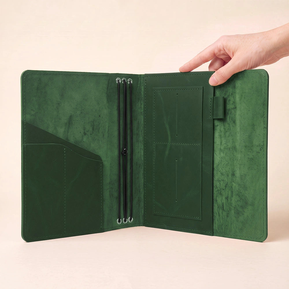 Premium leather writing notebook holder with functional compartments and secure leather pen loop.