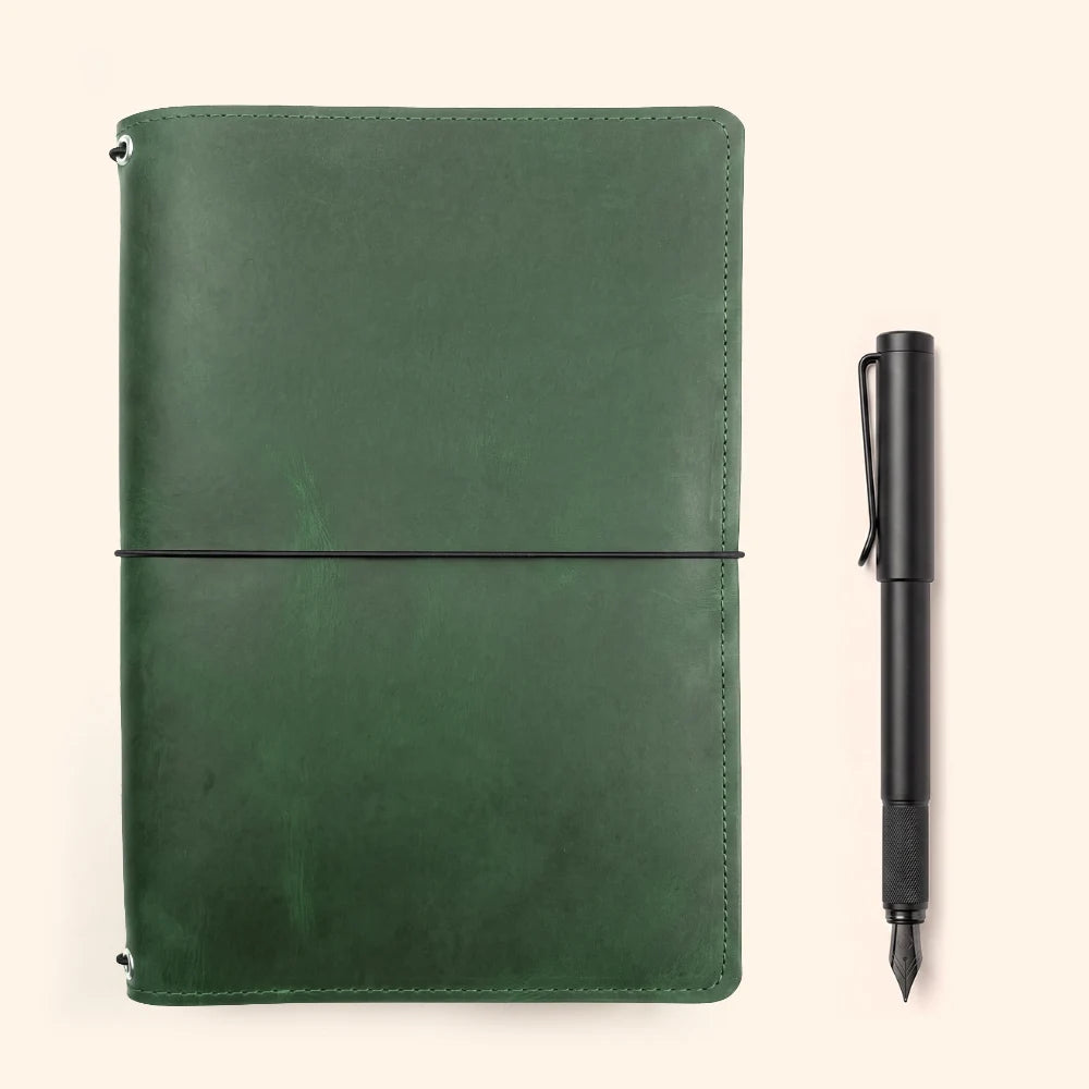Natural leather journal organizer with elastic cords for three replaceable notebooks.
