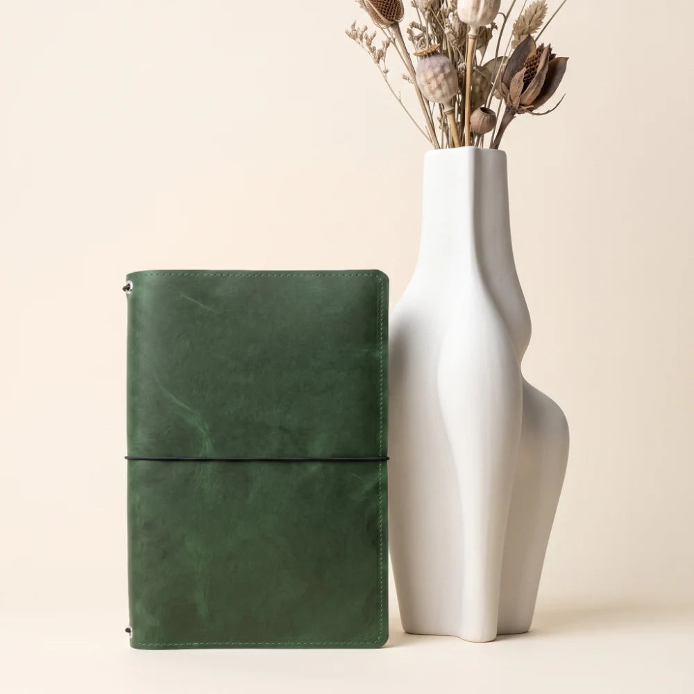 Genuine leather notebook holder designed with three interior bands for journal inserts.
