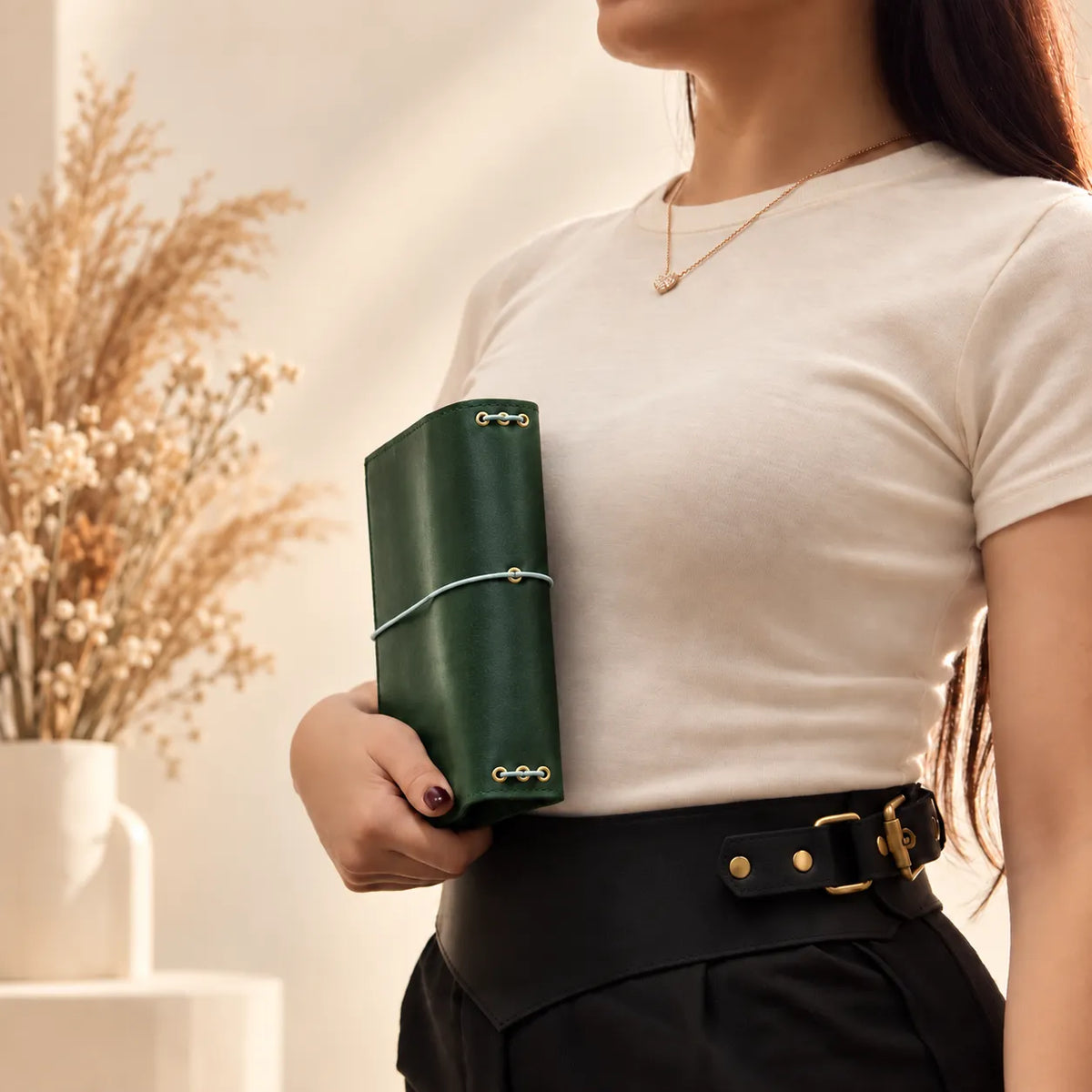 Woman holding a leather journal cover, highlighting the authentic grain of natural leather.