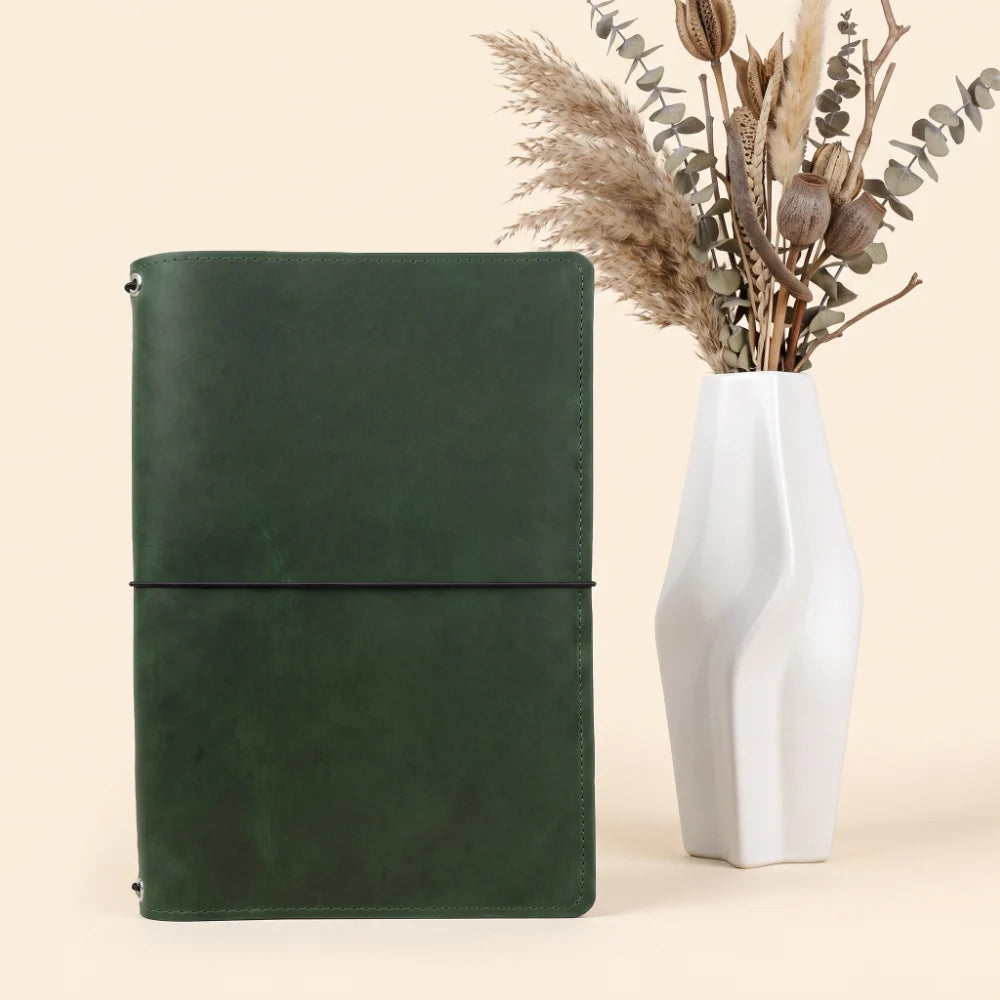 Handmade leather journal holder designed with three elastic bands inside.