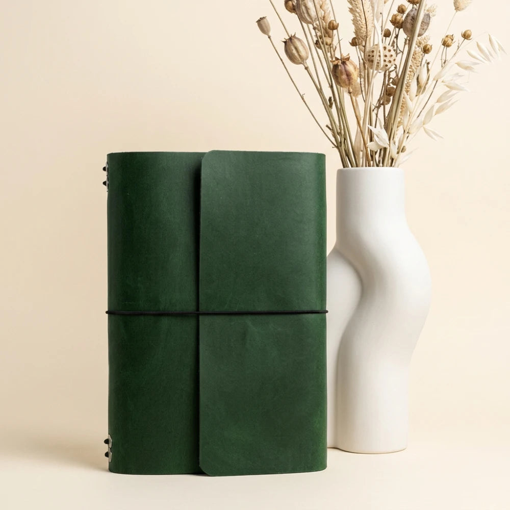 Minimal leather notebook holder featuring six interior elastic loops and pen storage.
