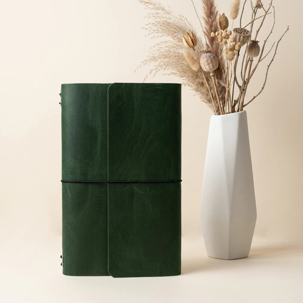 Reusable journal cover made from natural leather with six elastic insert holders.