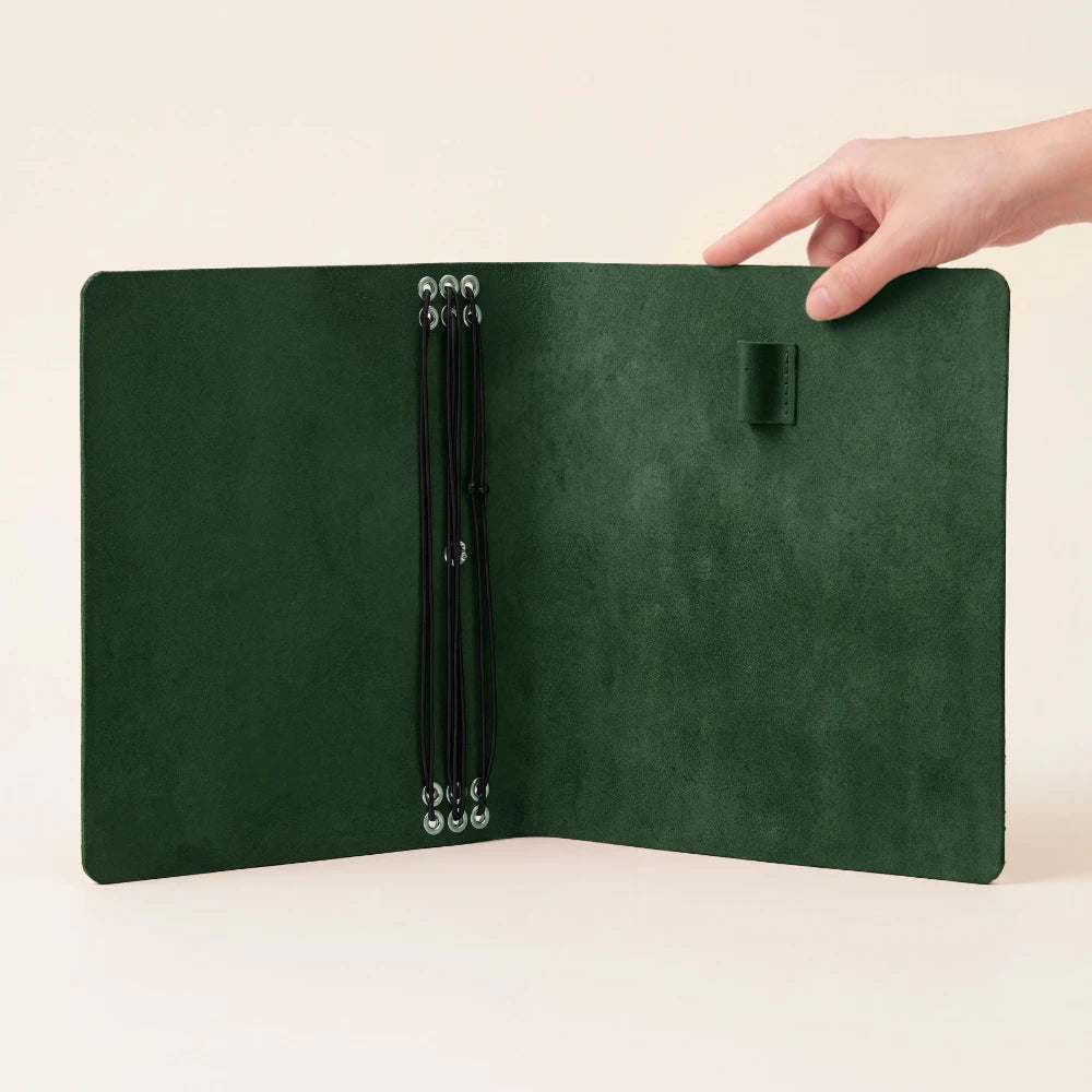 Leather writing organizer featuring six stretch bands for combining multiple notebook refills.