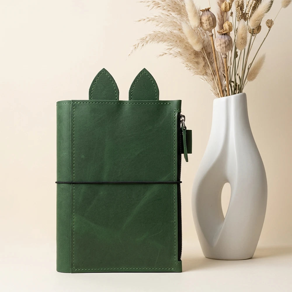 Open handmade leather cover featuring elegant stitching and a convenient pen loop.