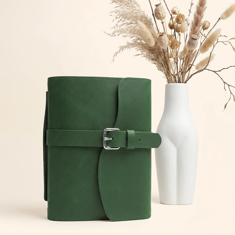 Genuine leather writing case with interior organizers, elastic pen loop, attached ribbon bookmark, and travel handle.