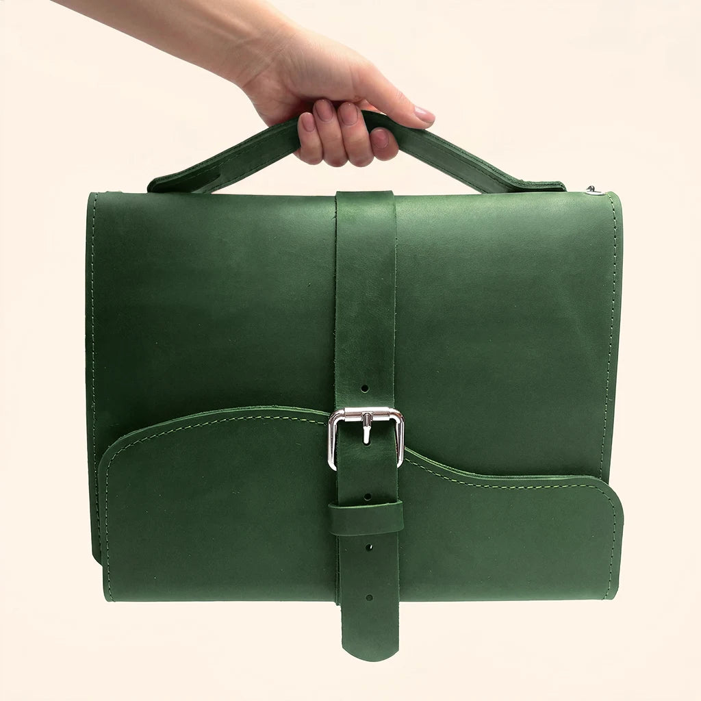 Natural leather cover for refillable journals with three elastic loops and carrying handle.