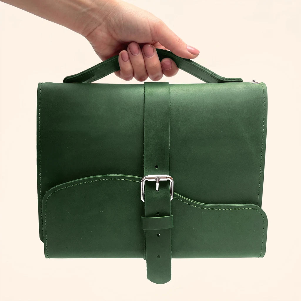 Durable natural leather journal holder with triple elastic loops and exterior carrying handle.