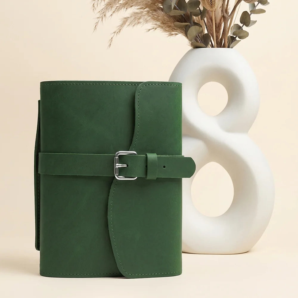 Genuine leather journal cover showcasing organized pockets, elastic pen loop, integrated bookmark, and functional outer handle.