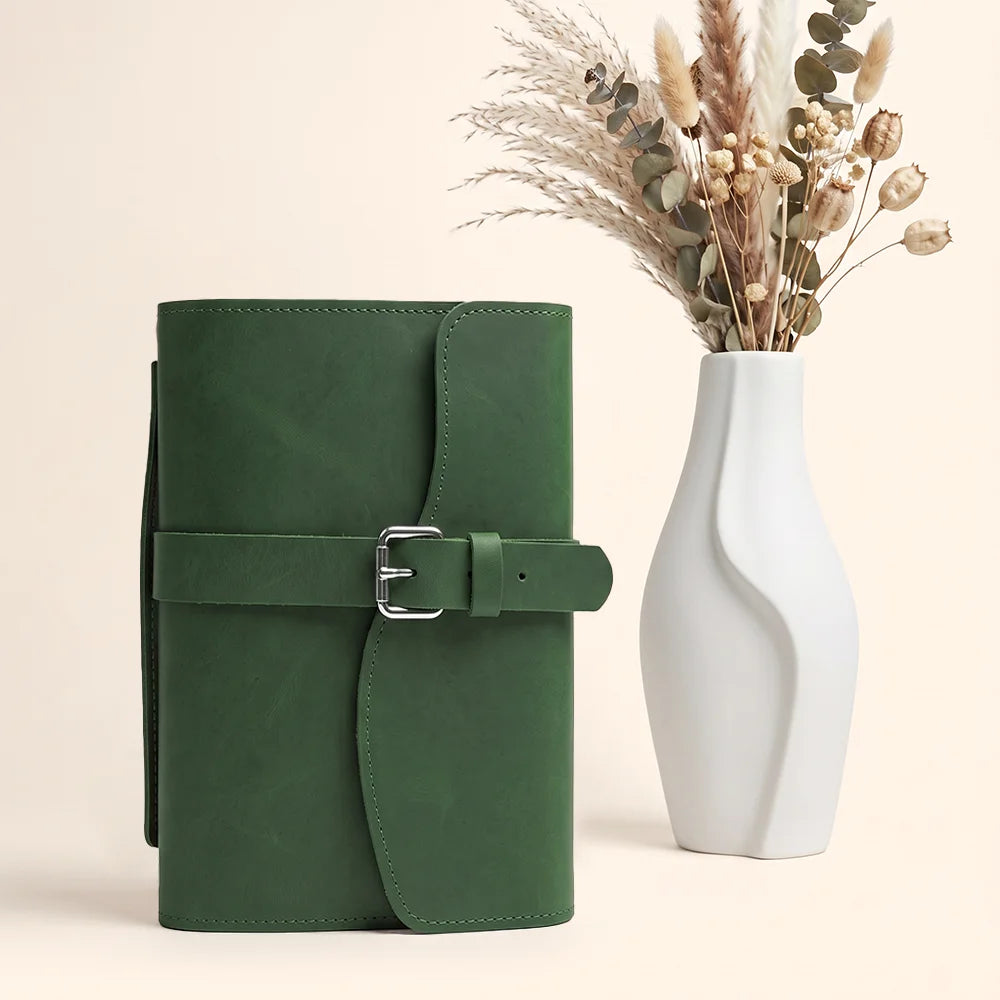 Premium leather journal cover showcasing inner pockets, pen loop, bookmark ribbon, and durable carry handle.