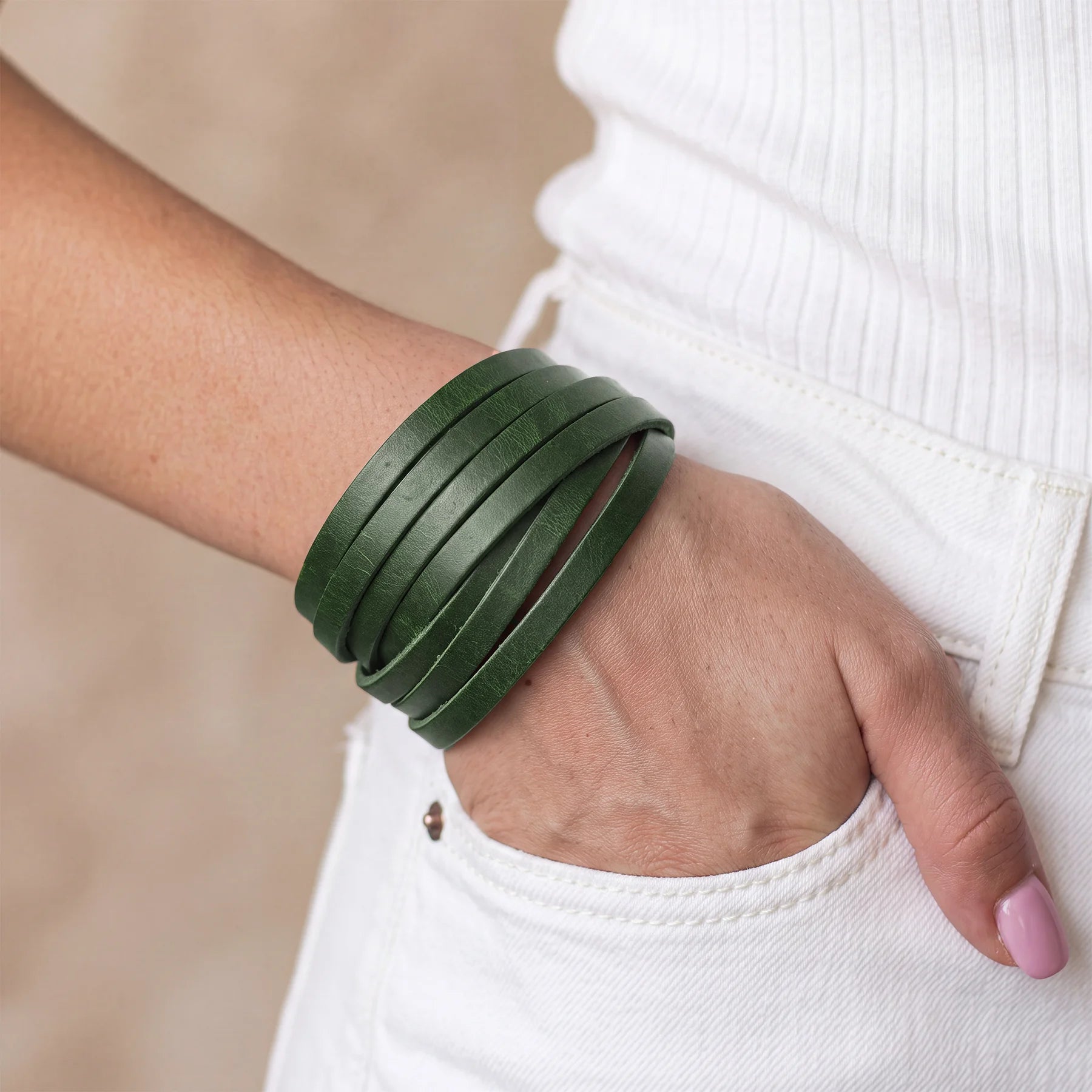 Rustic genuine leather bracelet secured with a durable metal snap button closure.