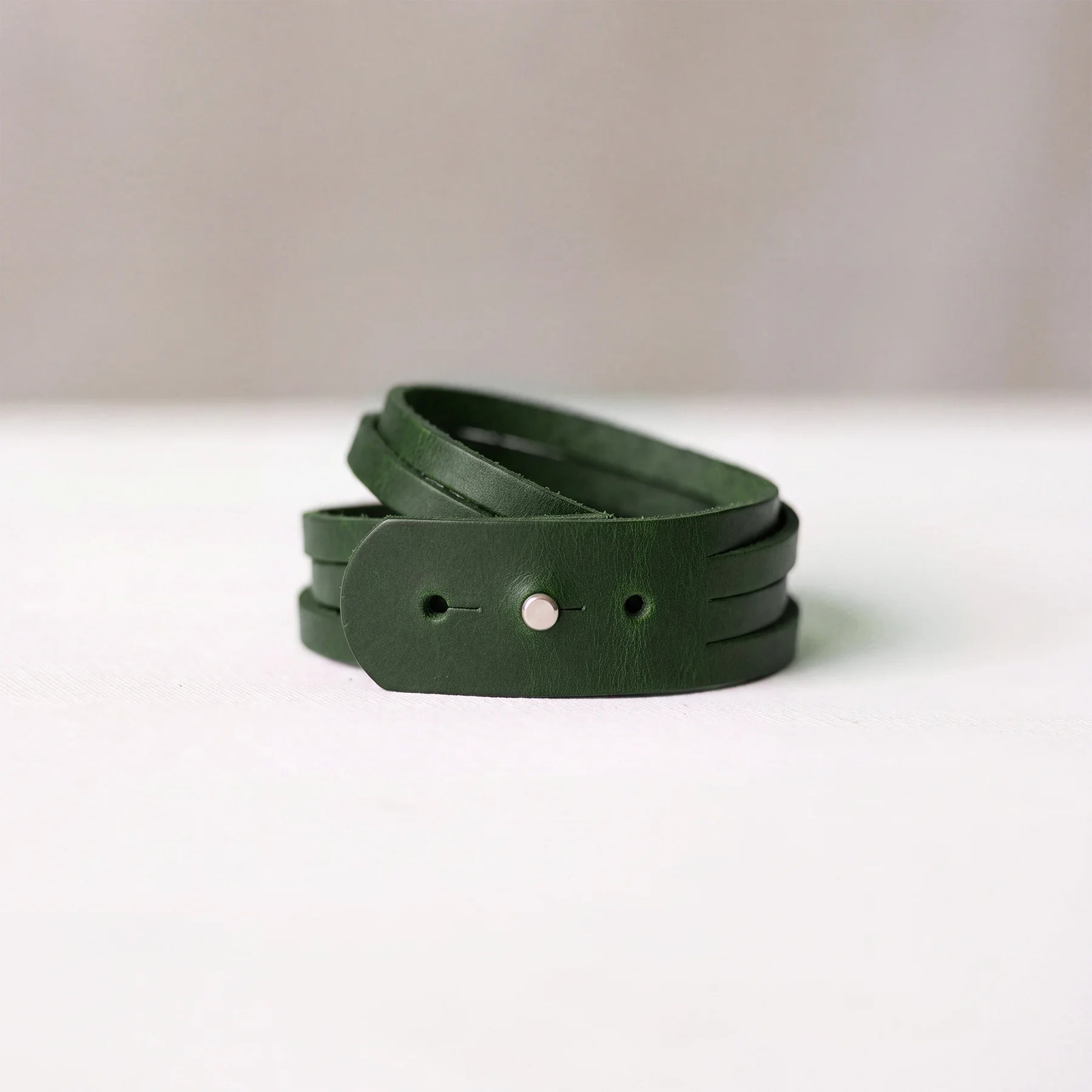 Elegant handcrafted leather bracelet with minimalist design and reliable snap button fastening.