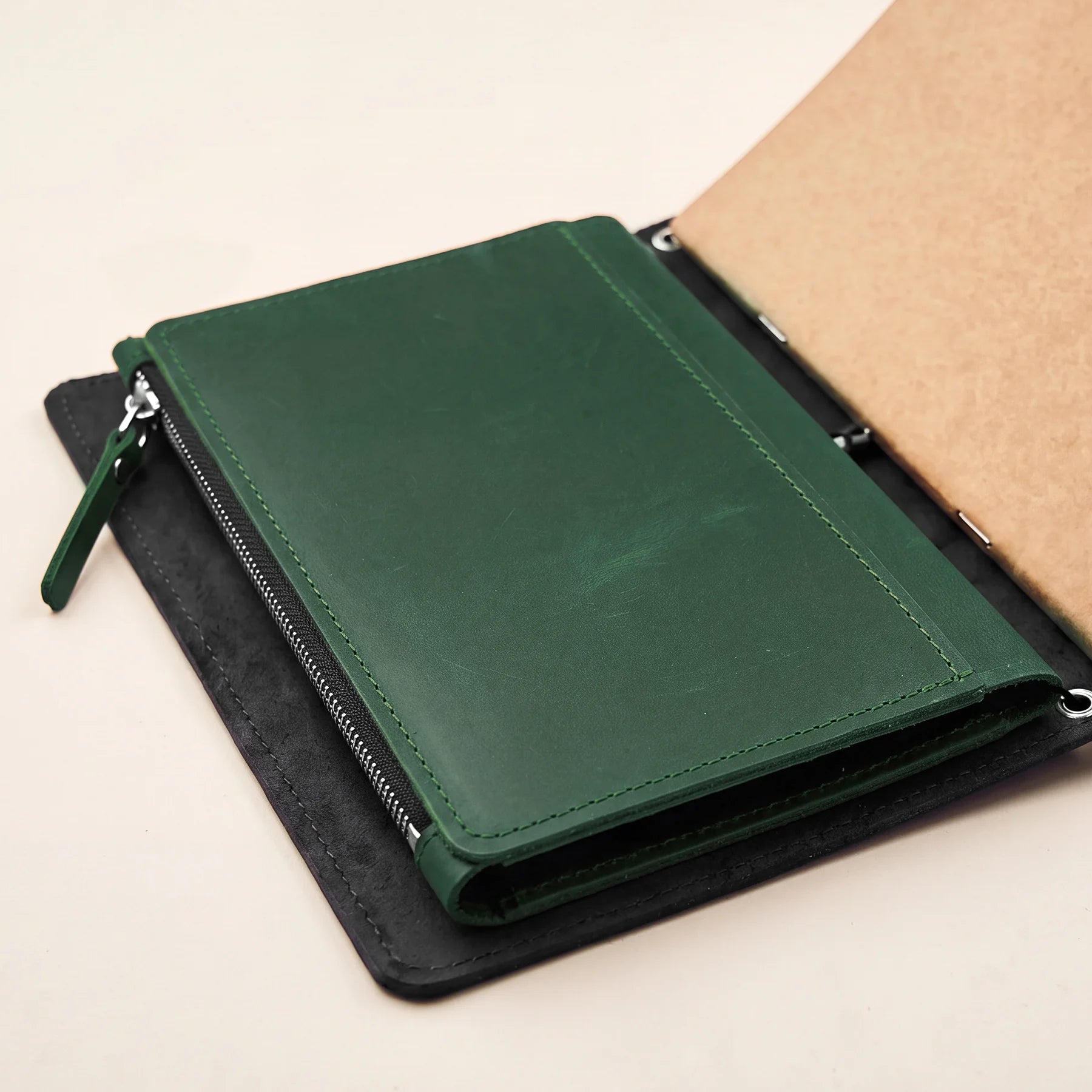 Premium leather insert with storage pockets for elastic notebook organizers and planners.