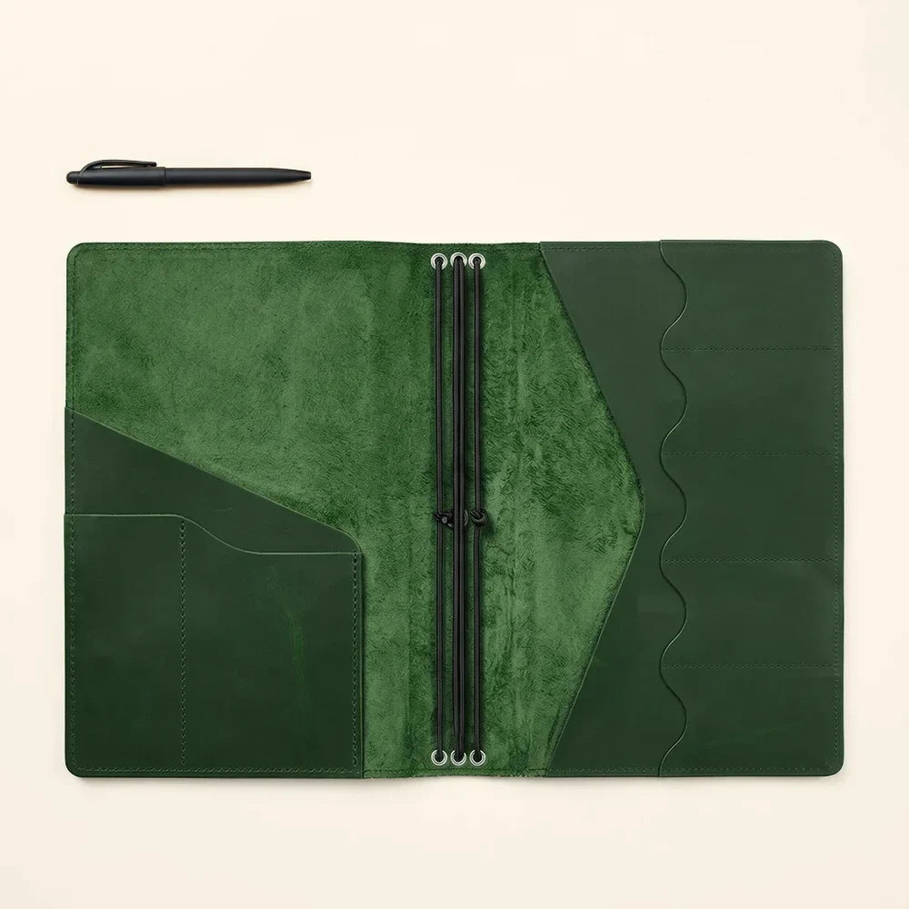 Handmade leather notebook cover offering card storage and refillable notebook organization.