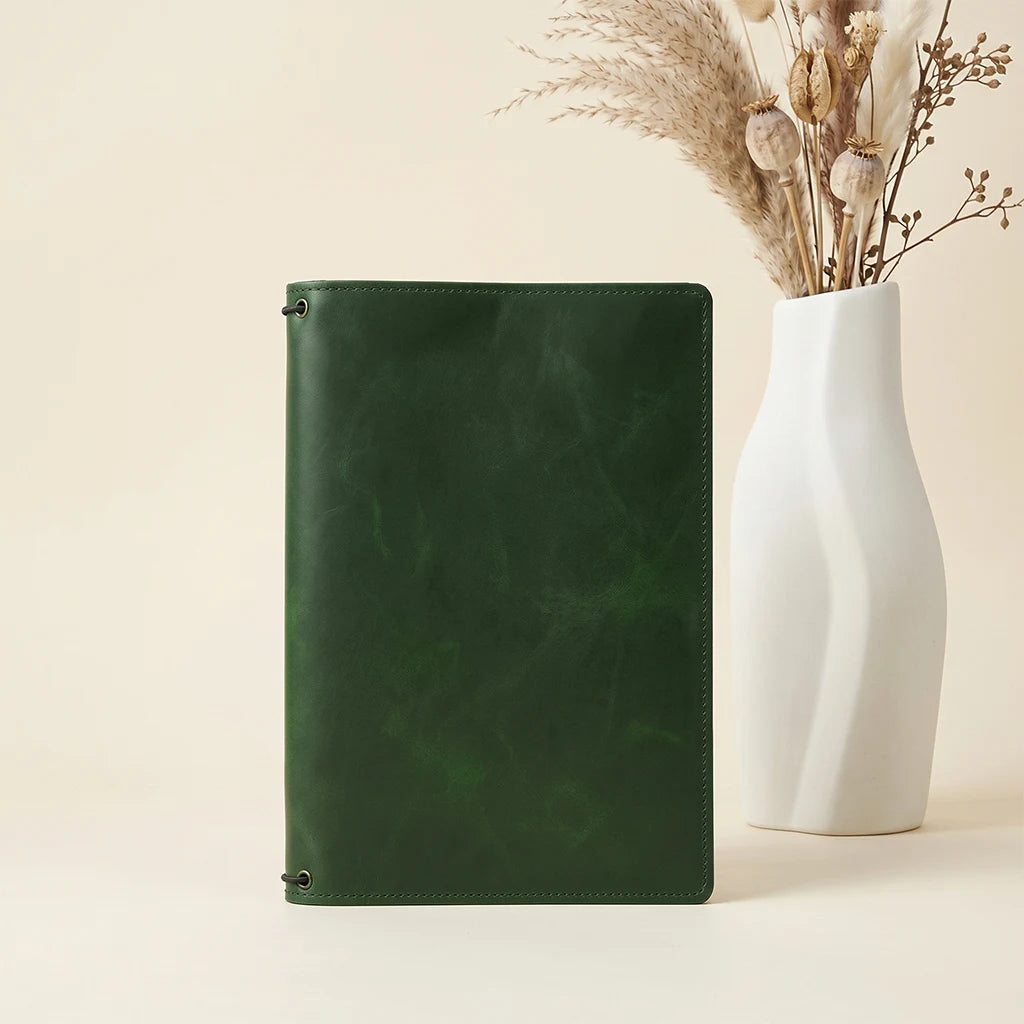 Genuine leather notebook wrap with multiple insert capacity and storage.