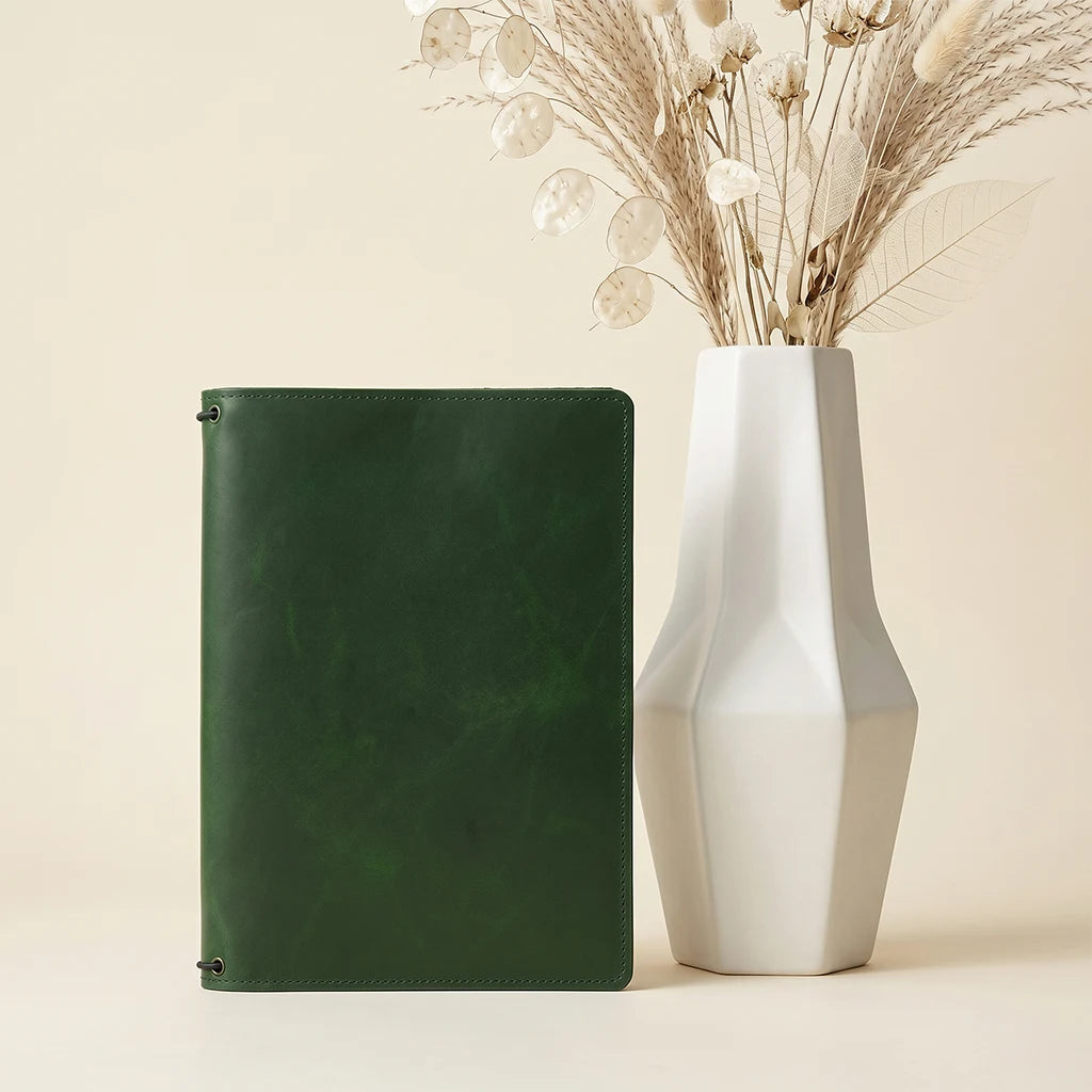 Genuine leather journal cover with refillable inserts and interior pockets.