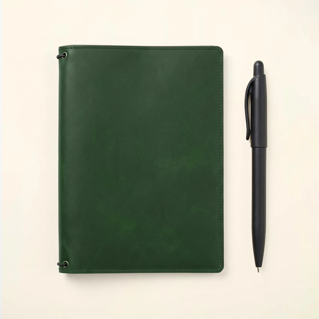 Refillable journal cover crafted from full grain leather with interior storage.
