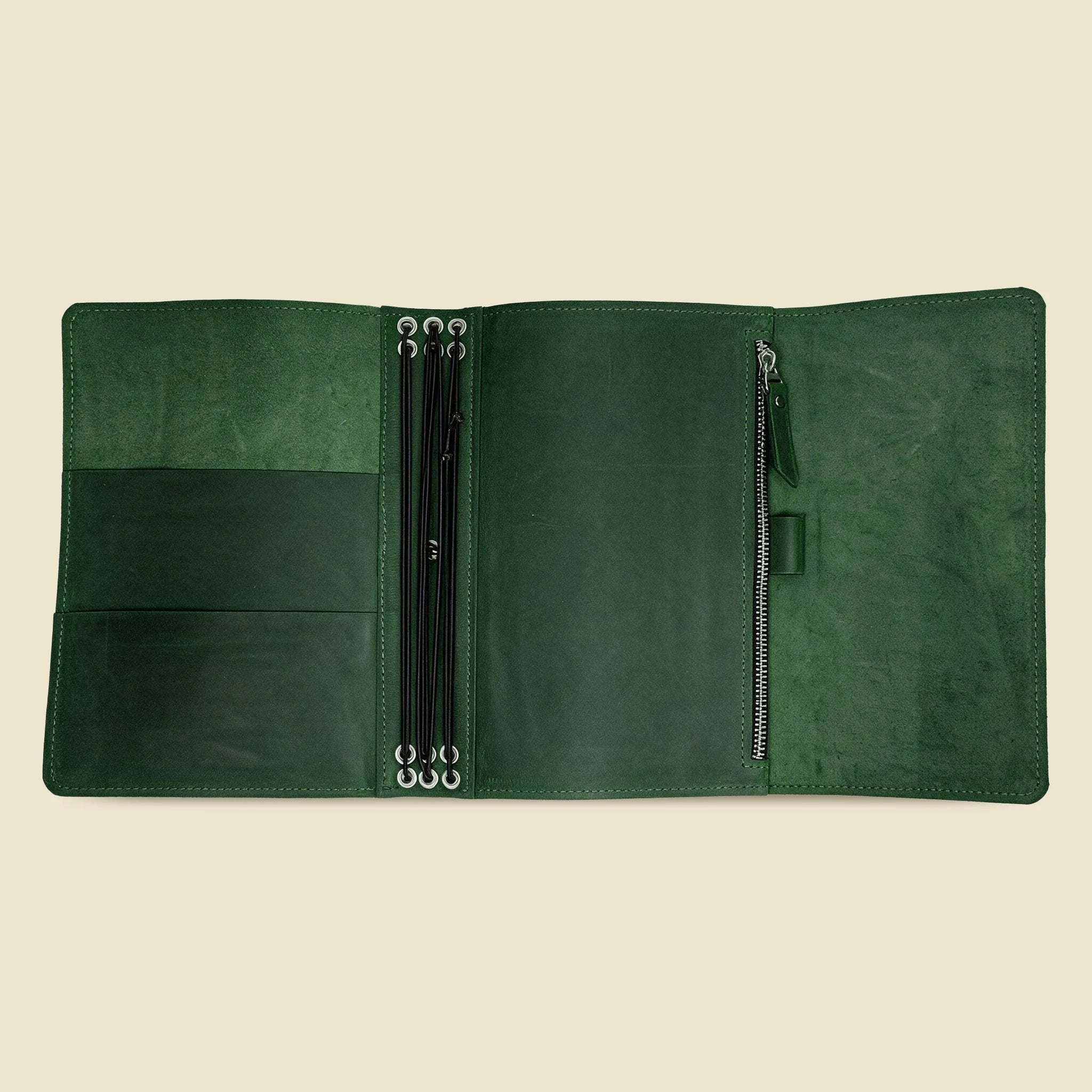 Leather travel journal cover with six elastic bands, functional pockets, and integrated pen holder.